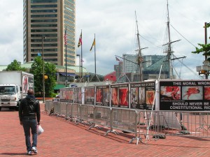 The masts of the USS Constellation rise above the GAP signs. The masts of the USS Constellation rise above the GAP signs.