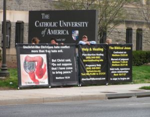 Challenging students and passersby alike in front of Catholic University of America.